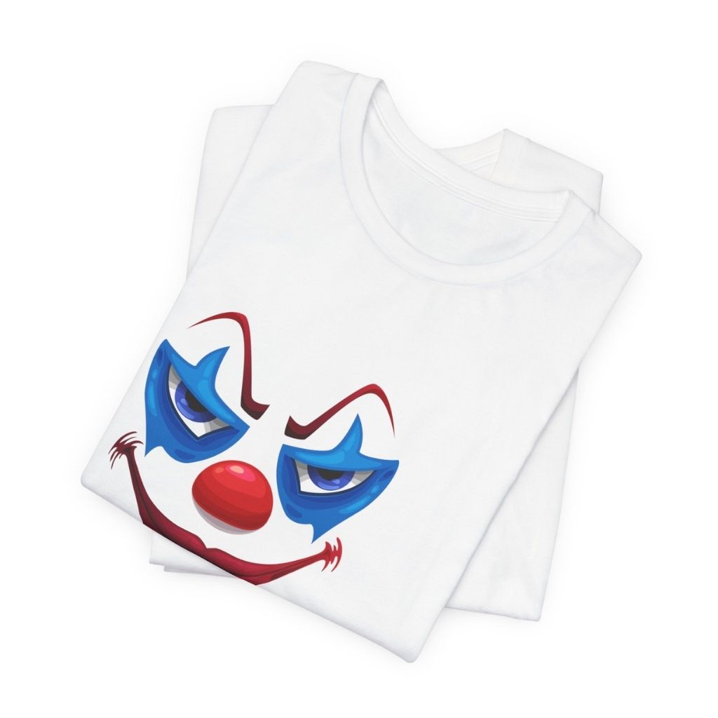 A neatly folded white t-shirt showing the details of the evil clown graphic with "Enter If You Dare..." text.
