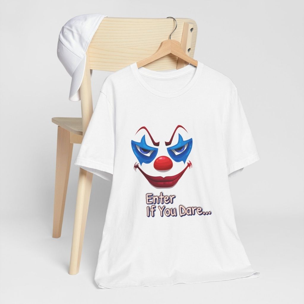 The "Enter If You Dare..." scary clown t-shirt hanging on a wooden chair against a clean, white background.
