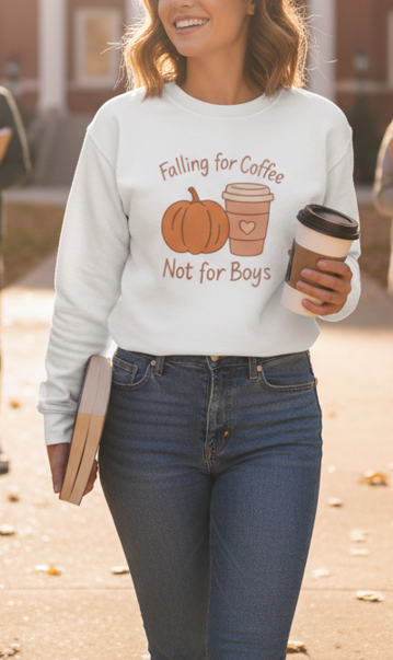 Woman wearing a sweatshirt with a pumpkin and coffee cup graphic, holding a coffee cup.