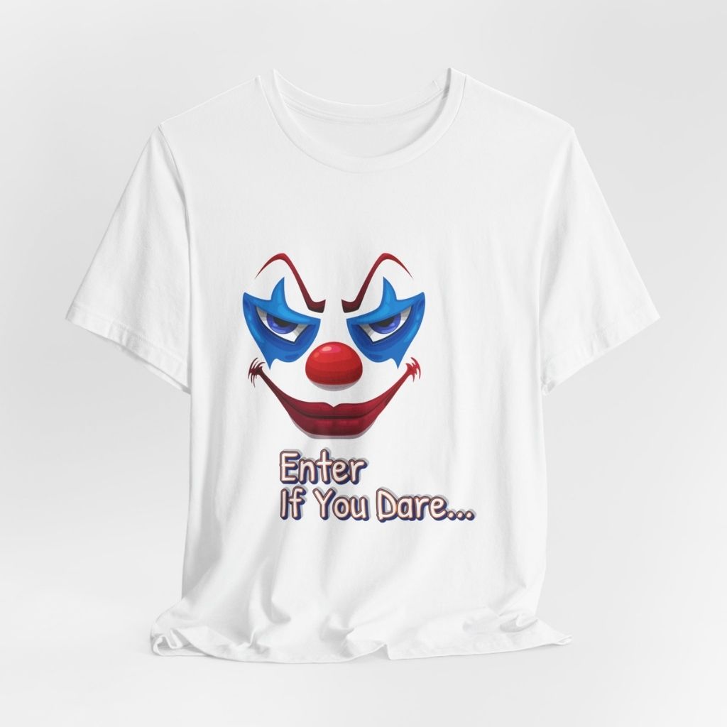 A flat lay of the white graphic t-shirt featuring the scary clown face and the text "Enter If You Dare...".