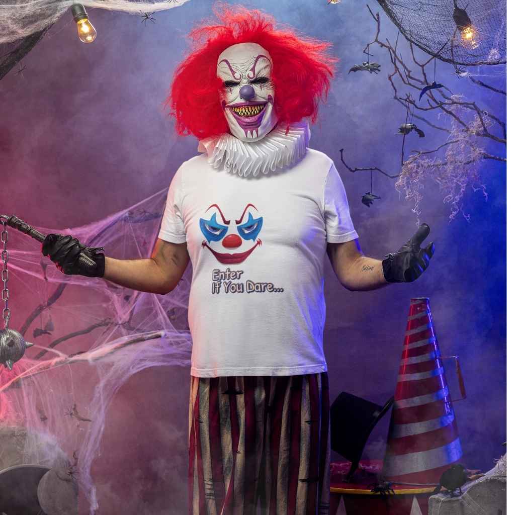 Person in a scary clown Halloween costume with arms outstretched in a spooky pose, wearing the "Enter If You Dare..." graphic tee.